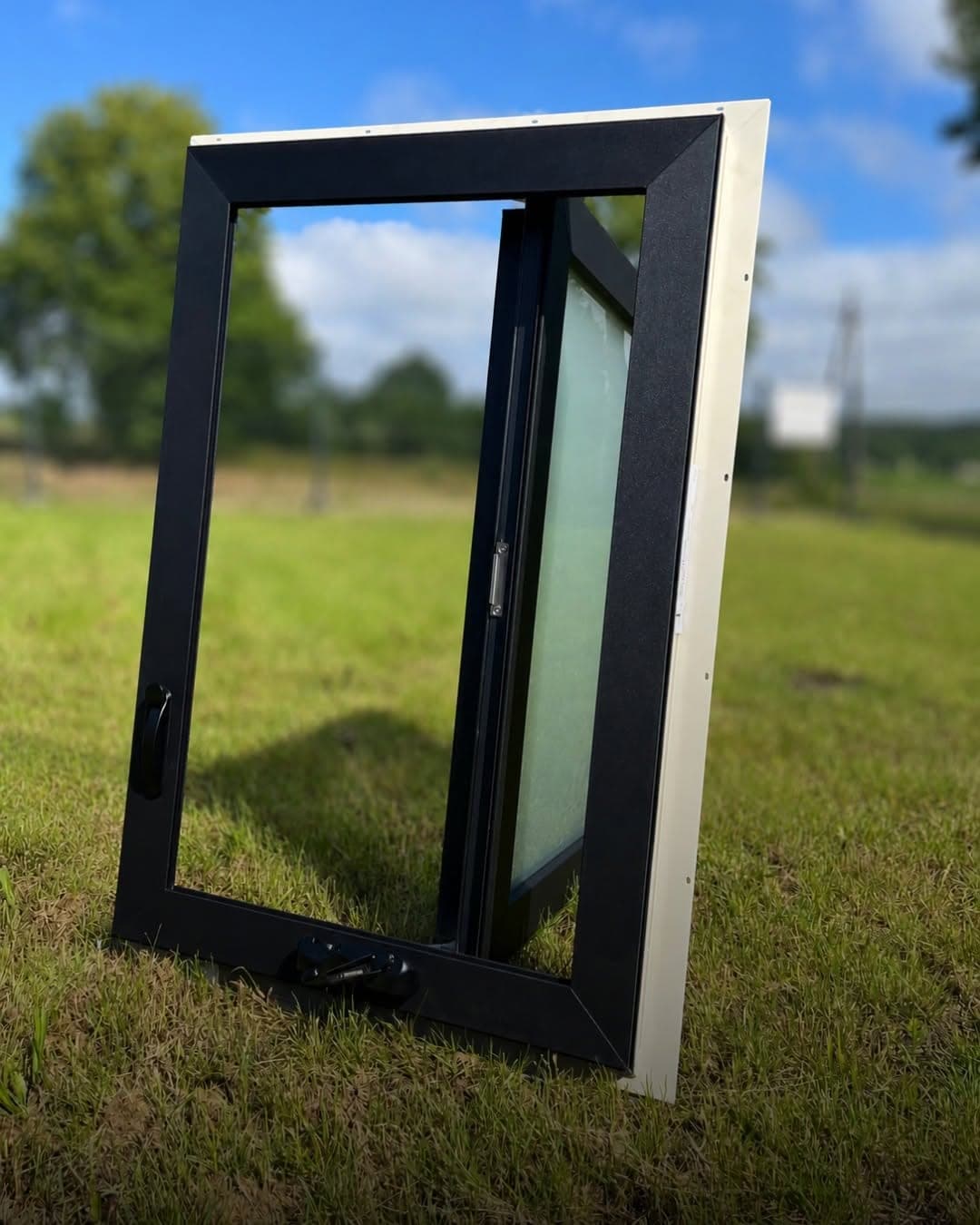Outward-opening European casement sash swung open, showing the insulated glass unit and hinge side
