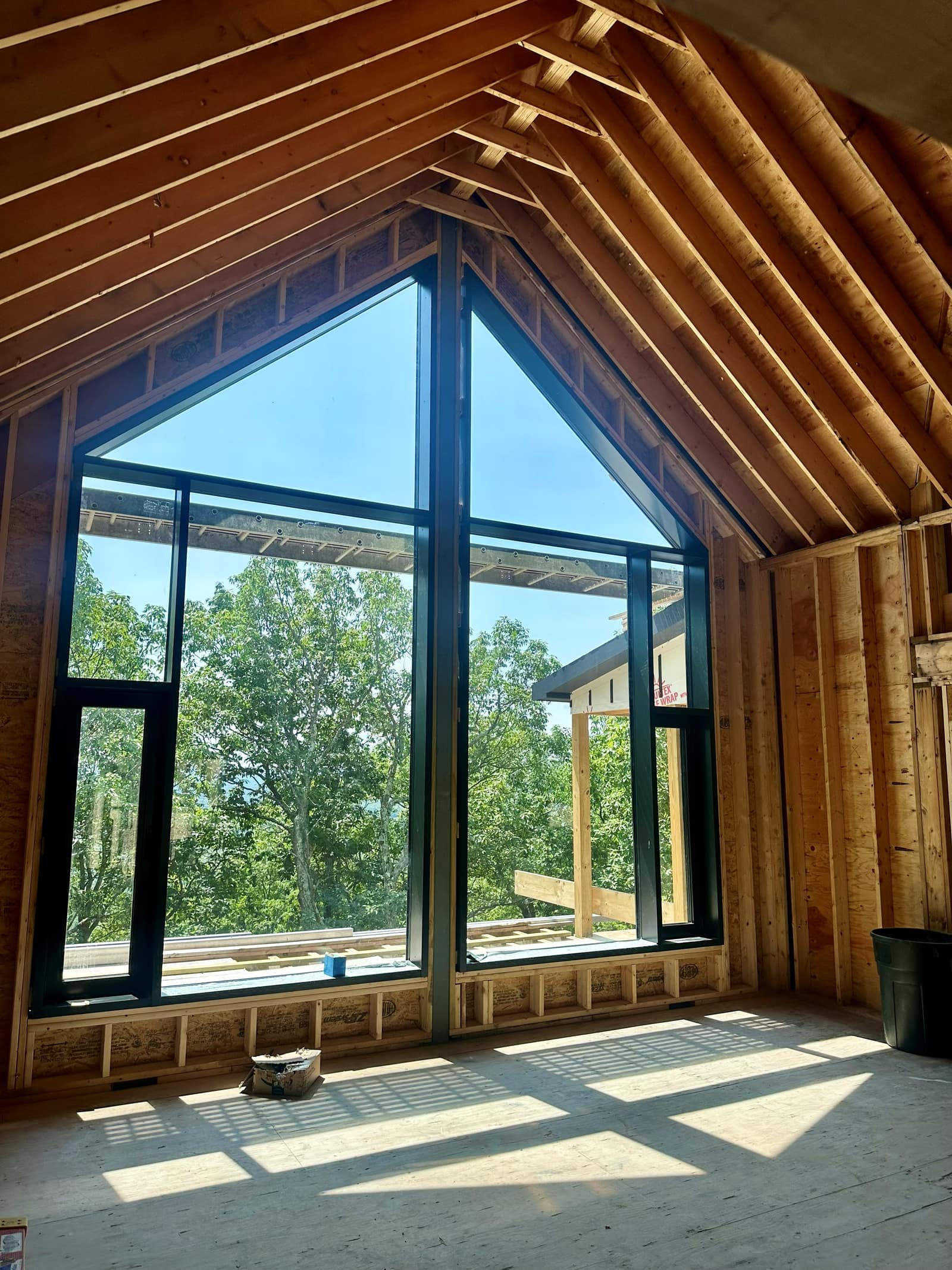 The living room gable in curtain wall - raking head members following the roof pitch.