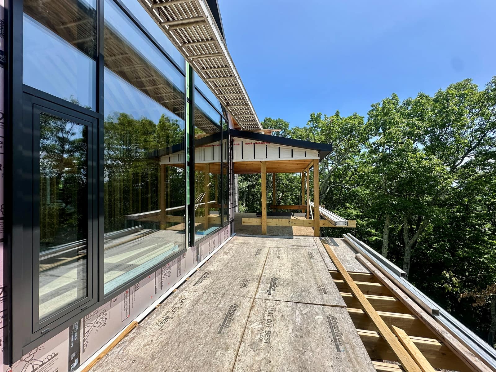 Curtain wall run along the covered deck, seen from outside.