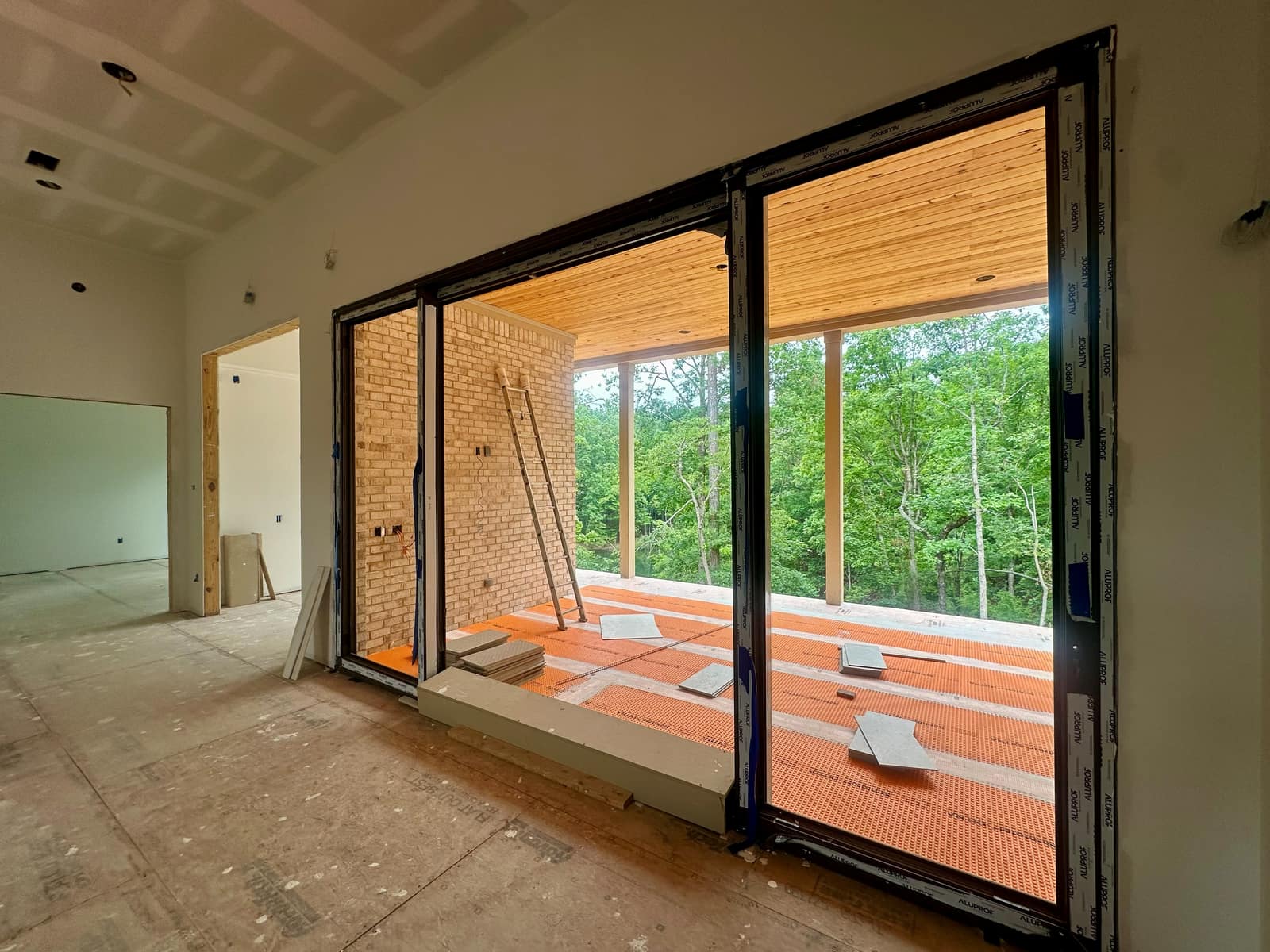 Lift & slide door open onto the covered porch - the panel runs on a low threshold instead of swinging into the room.