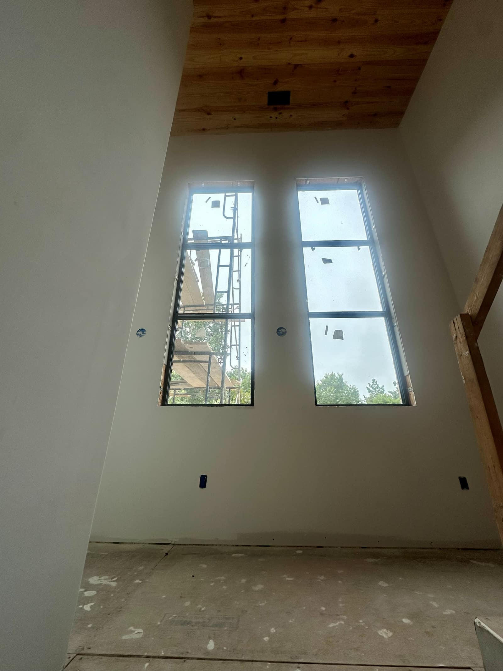 Double-height glazing carrying daylight up to the second floor.