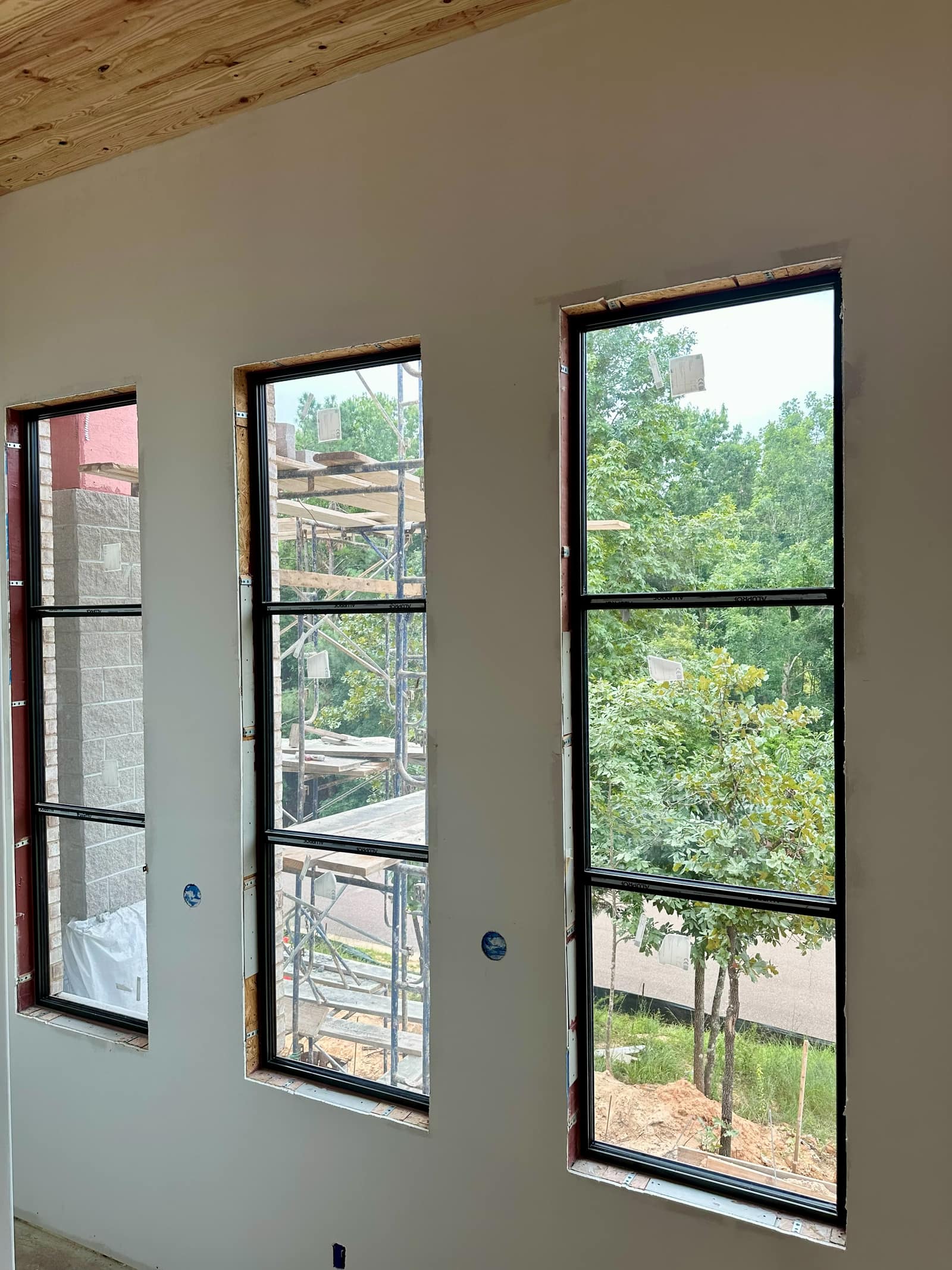Paired full-height units with fixed transoms above.