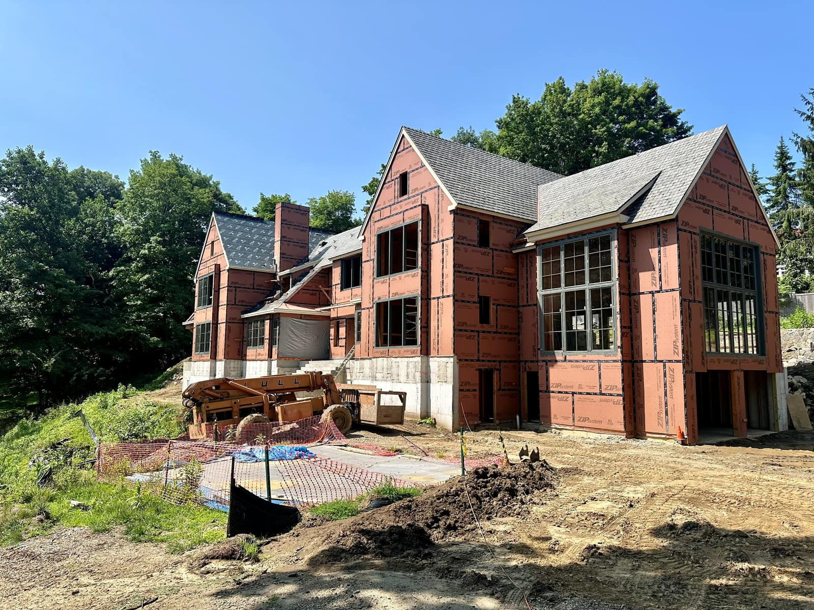 Full elevation from the drive, windows in ahead of cladding.