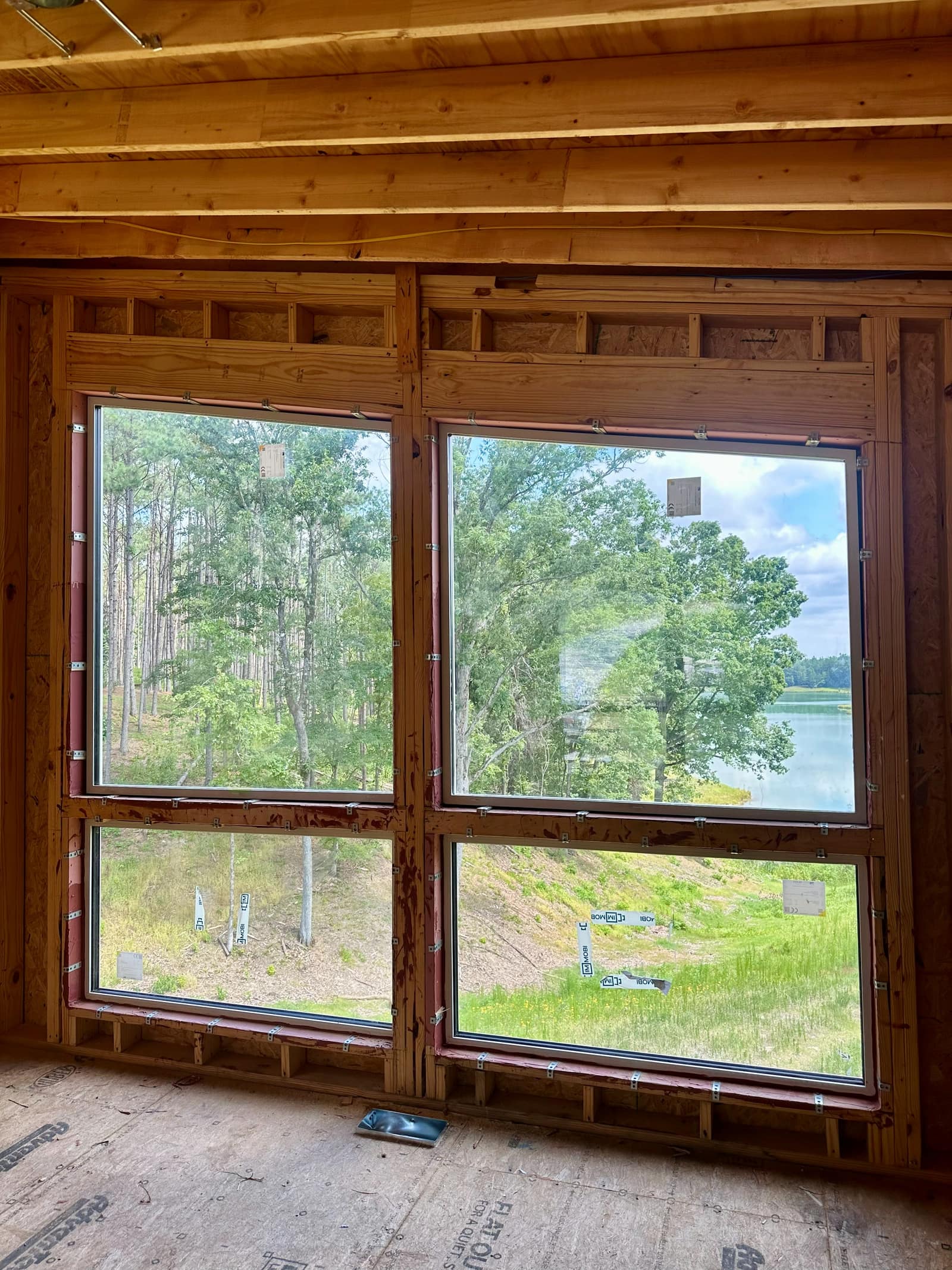 Window wall at floor level, still in open framing.
