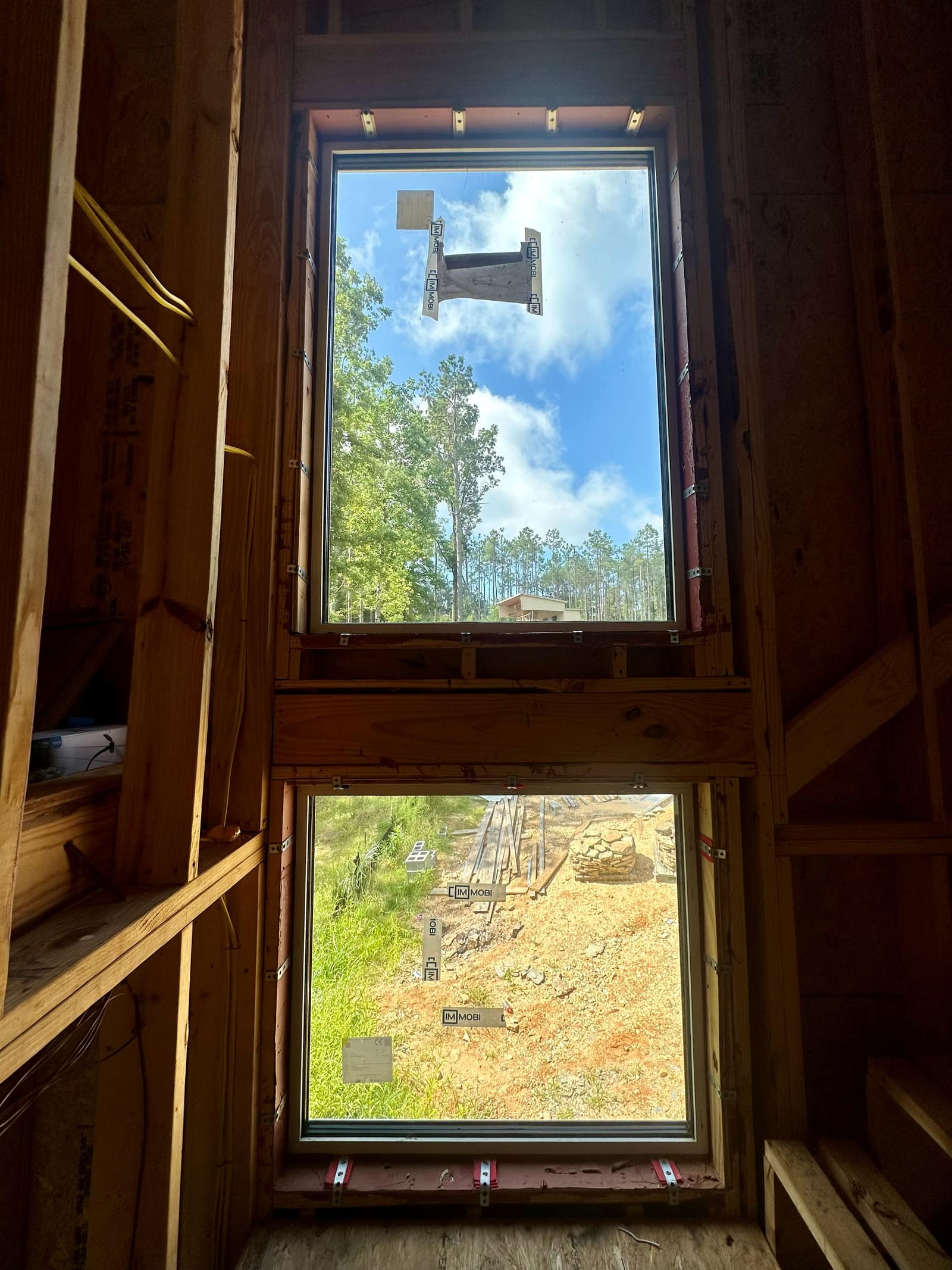 Stacked units in the framed opening - upper light over lower unit.
