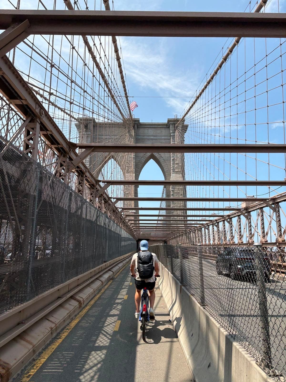 Kai Adamek cycling across the Brooklyn Bridge in New York